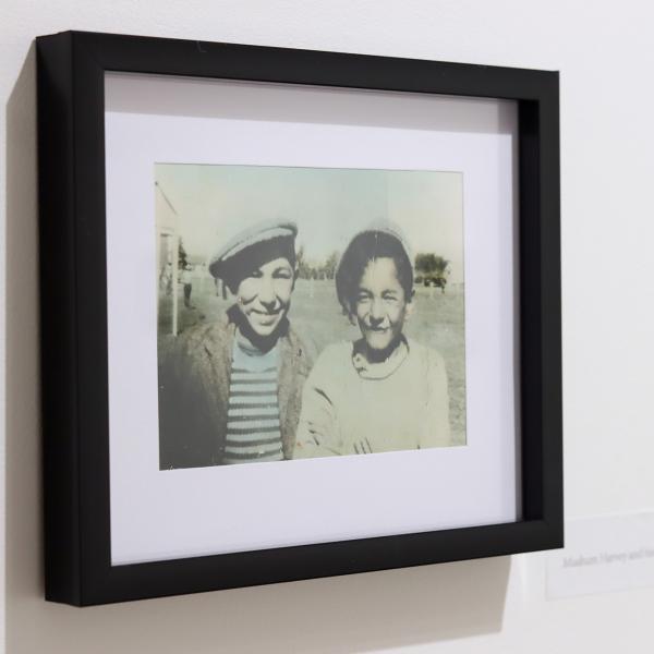 Atticus Mercredi's family photos on the View Gallery's wall.