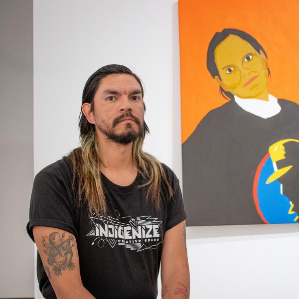 Atticus Mercredi with the portrait he painted of his mother.