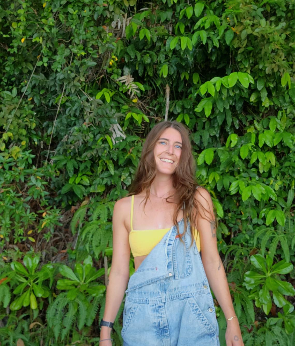 Katie Temporal in front of lush green foliage