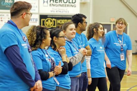 a group of students wearing VIU T-Shirts addresses a crowd