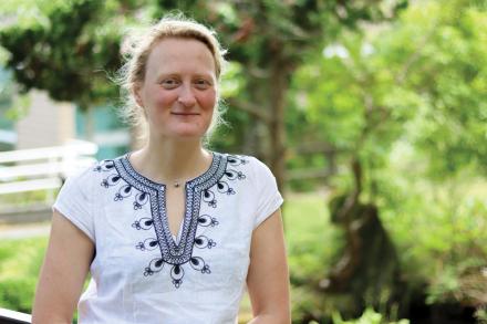 Jenni Ottilie Keppler stands on the koi pond bridge at Vancouver Island University's Nanaimo campus.